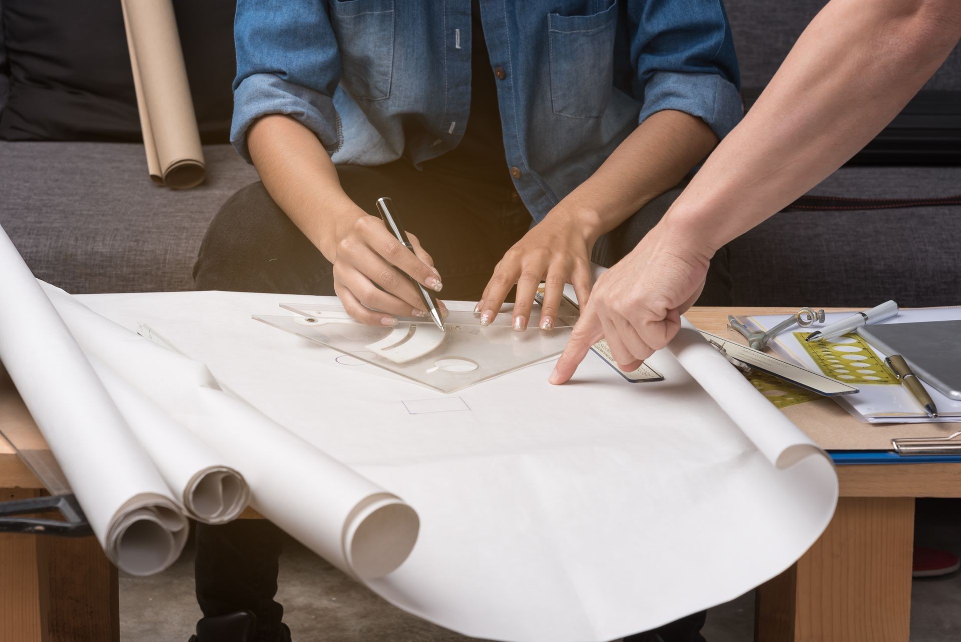 Business woman engineer in working time.The team's hand point to drawing paper during meeting, Busy and work hard. Business woman engineer in working time.The team's hand point to drawing paper during meeting, Busy and work hard.